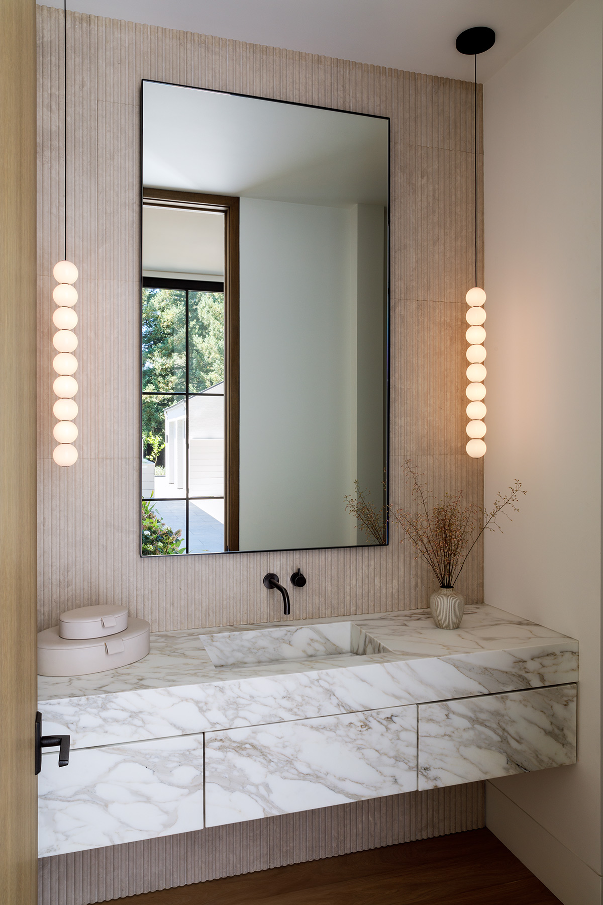 Photographer: Michele Willson • Fabricators: Marble & Stone Solutions and Emperador Marble • Architect: PNC Development • Materials: Sink - Calacatta Borghini Honed, Backsplash - Creme de Provence Fluted