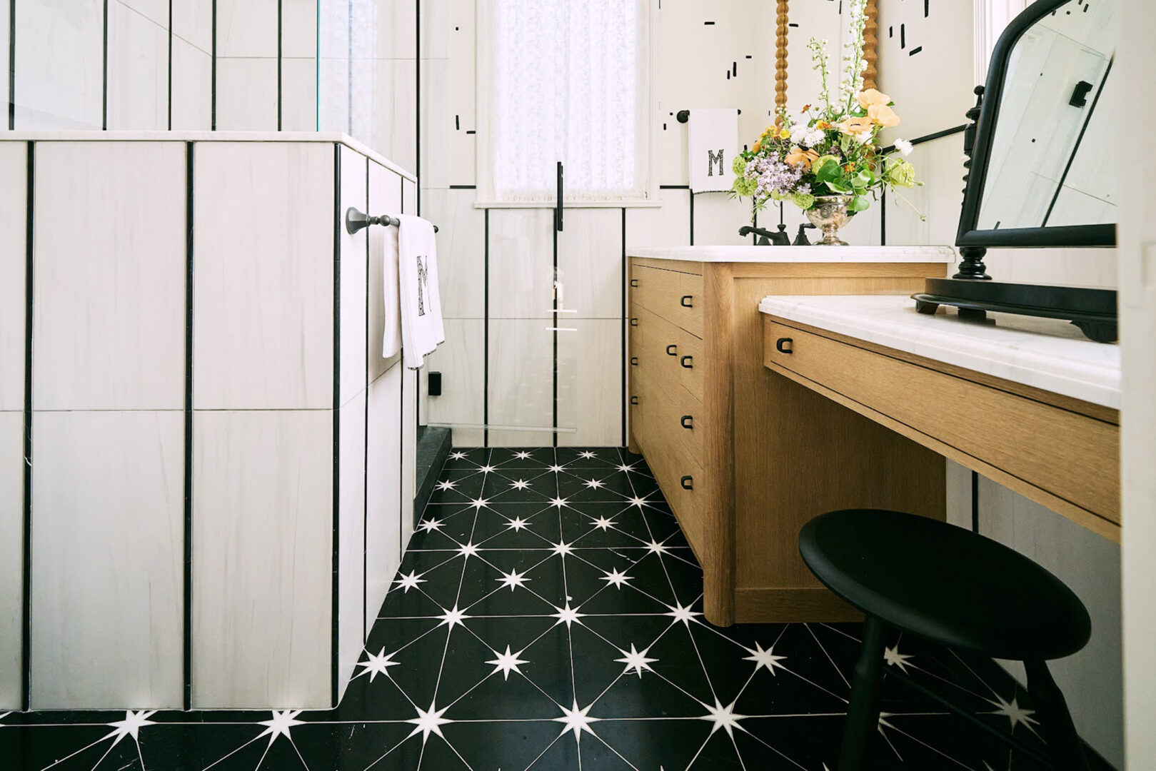 Chantal Lamberto Interior Design | Calacatta Spider Honed Marble (Vanity Top) | New Ravenna Orion Mosaic in Nero Marquina Honed + Dolomite Polished (Floor) | Photo by Bess Friday Slab