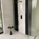 Designer: JIA XU | Architect: Stacey Olgado | Materials: Floor - Enrichment Weave 12, Blanc Dolomite Maison Surface; Shower Walls - Dolomite Polished (left), Thassos Polished (right), Negro Marquina (black stripes)