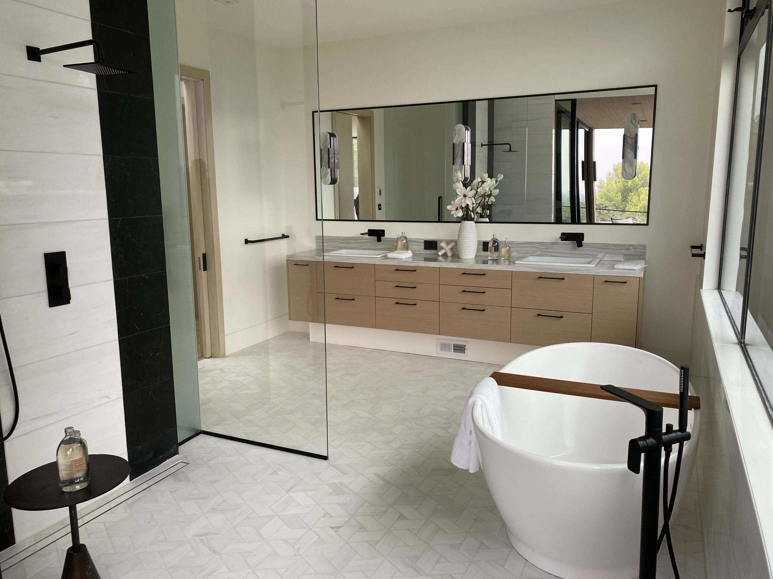 Designer: JIA XU | Architect: Stacey Olgado | Materials: Floor - Enrichment Weave 12, Blanc Dolomite Maison Surface; Shower Walls - Dolomite Polished (left), Thassos Polished (right), Negro Marquina (black stripes)