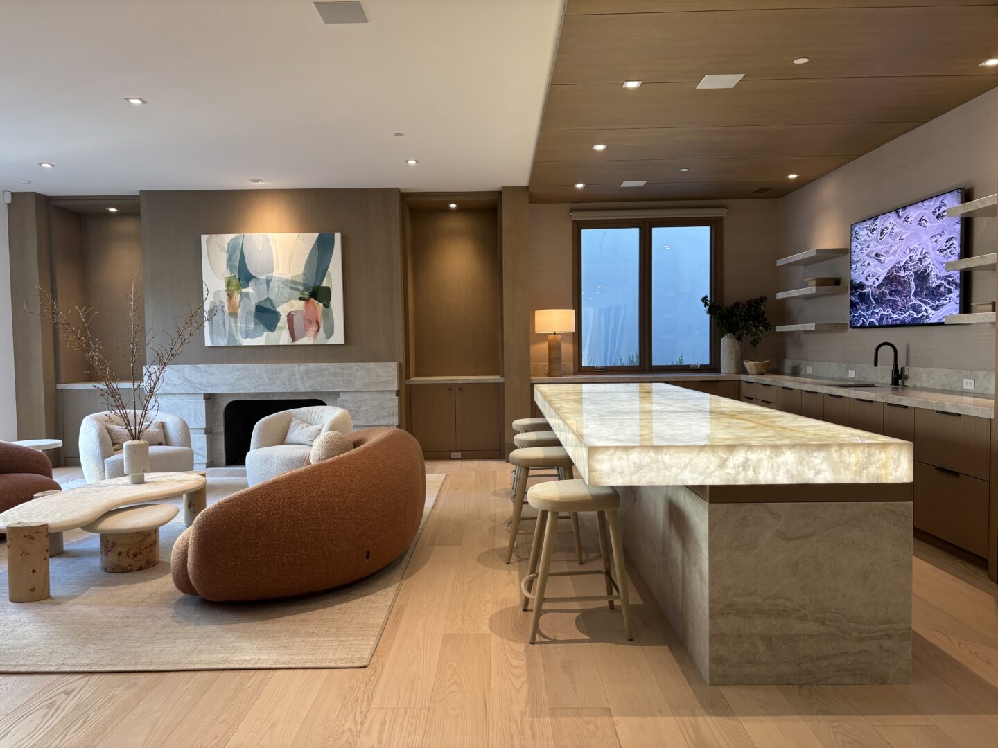 Architect, Designer & Builder: PPG | Materials: Quartzite Bianco (bar top), Taj Mahal (counter, bar base, fireplace) Slab