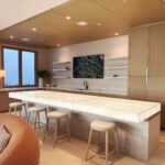 Architect, Designer & Builder: PPG | Materials: Quartzite Bianco (bar top), Taj Mahal (counter, bar base, fireplace) Slab