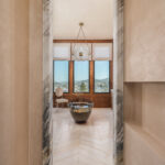 Designer: Lauren Berry | Photographer: Christopher Stark | Materials: Calacatta Borghini Honed Marble, Vanilla Onyx Vein Cut Honed Chevron Slab