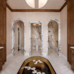 Designer: Lauren Berry | Photographer: Christopher Stark | Materials: Calacatta Borghini Honed Marble, Vanilla Onyx Vein Cut Honed Chevron Slab