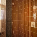 Designer: AubreyMaxwell Design & Perez Construction | Photographer: R. Brad Knipstein | Materials: Essential Collection Tiles in Dijon by McIntyre Tile (shower walls & backsplash); Zedonia Terrazza by Sonoma Tilemakers (side panel & floor) Slab