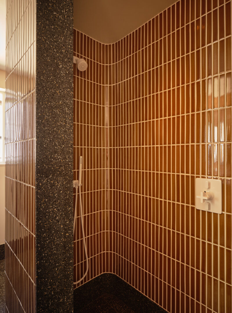Designer: AubreyMaxwell Design & Perez Construction | Photographer: R. Brad Knipstein | Materials: Essential Collection Tiles in Dijon by McIntyre Tile (shower walls & backsplash); Zedonia Terrazza by Sonoma Tilemakers (side panel & floor) Slab