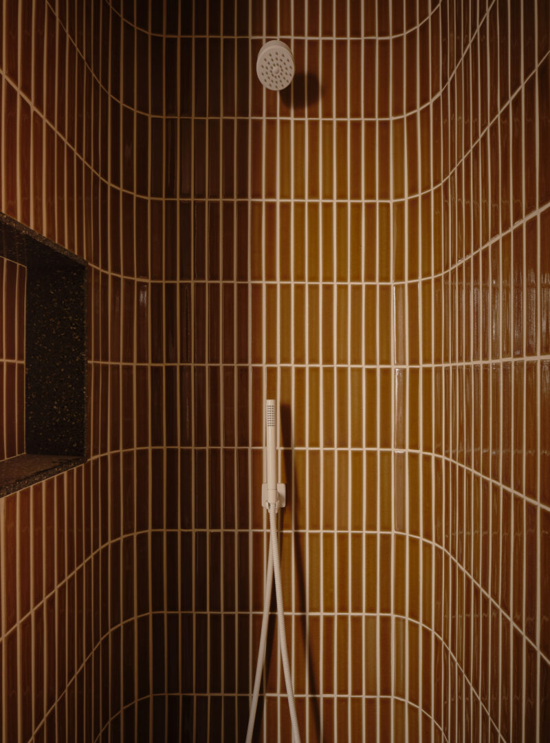 Designer: AubreyMaxwell Design & Perez Construction | Photographer: R. Brad Knipstein | Material: Essential Collection Tiles in Dijon by McIntyre Tile (shower walls & backsplash) Slab